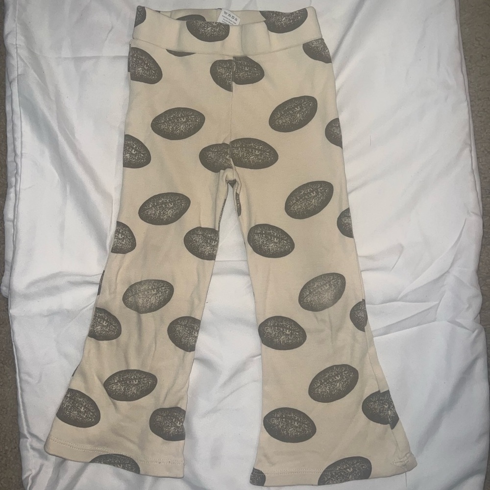 Kate Quinn Cream Pants with football patterns